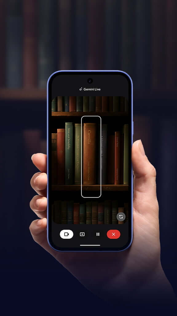 A hand holding a Pixel device in book shop environment, with rows of books on screen.