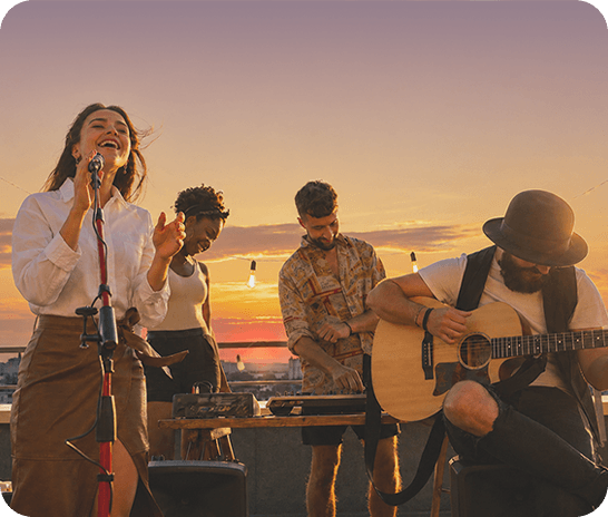 A low-light outdoor photo of several musicians performing at sunset, showing clear, vivid details with Nightography.